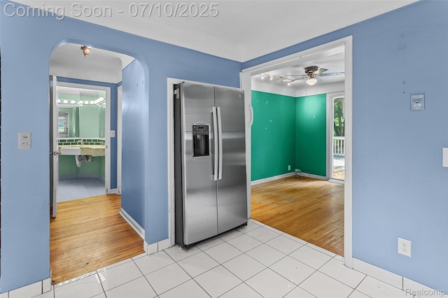 18930 Deering St, Melvindale, MI 48152 - kitchen with stainless steel fridge with ice dispenser, arched walkways, light tile patterned flooring, and ceiling fan