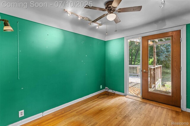18930 Deering St, Melvindale, MI 48152 - spare room with wood-type flooring, a ceiling fan, and rail lighting