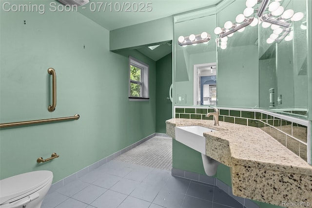 18930 Deering St, Melvindale, MI 48152 - bathroom featuring tile patterned floors, backsplash, and lofted ceiling