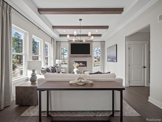 16257 Rogan Dr, Linden, MI 48451 - living room with dark wood-style flooring, beamed ceiling, a fireplace, and a chandelier