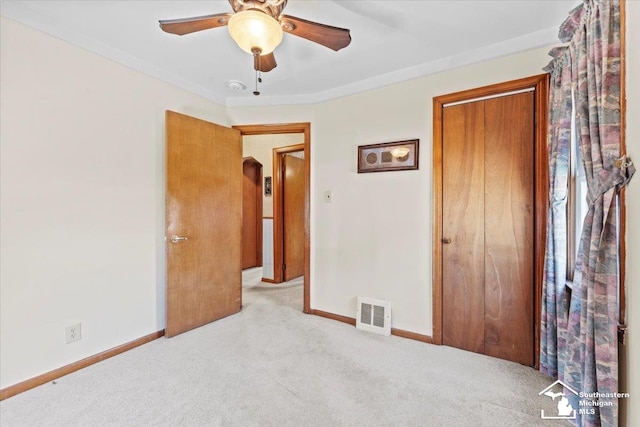 1508 12th St, Wyandotte, MI 48192 - unfurnished bedroom featuring carpet floors, a closet, a ceiling fan, and crown molding