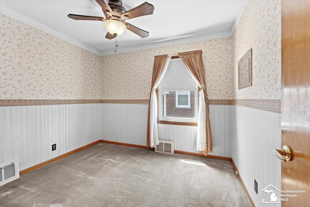 1508 12th St, Wyandotte, MI 48192 - unfurnished room with wallpapered walls, ceiling fan, carpet flooring, ornamental molding, and wainscoting