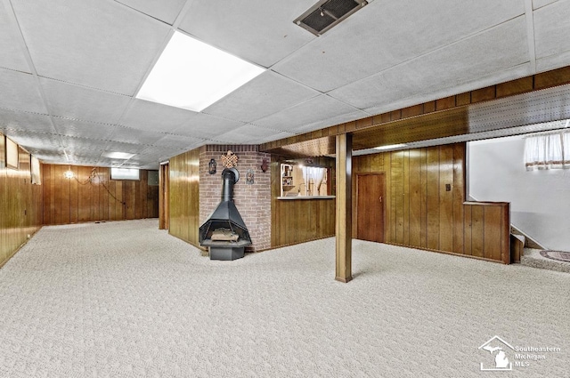 1508 12th St, Wyandotte, MI 48192 - finished below grade area with wood walls, a wood stove, and carpet flooring