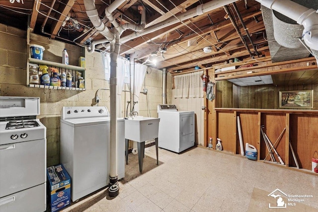 1508 12th St, Wyandotte, MI 48192 - washroom with separate washer and dryer, tile patterned floors, and concrete block wall