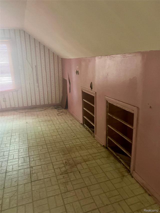 638 W Pulaski Ave, Flint, MI 48505 - bonus room featuring vaulted ceiling, brick patterned floors, and wallpapered walls
