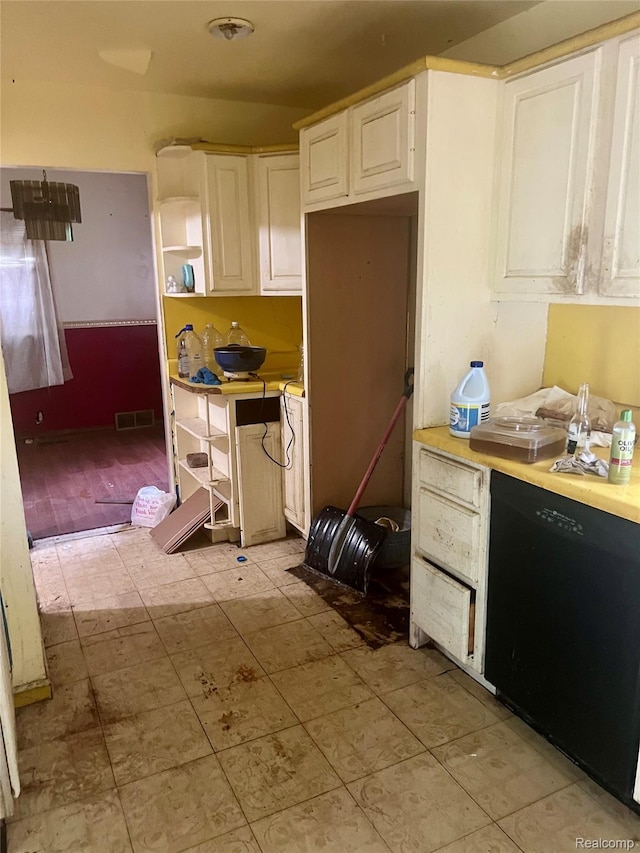 638 W Pulaski Ave, Flint, MI 48505 - kitchen with black dishwasher, open shelves, light countertops, and white cabinetry