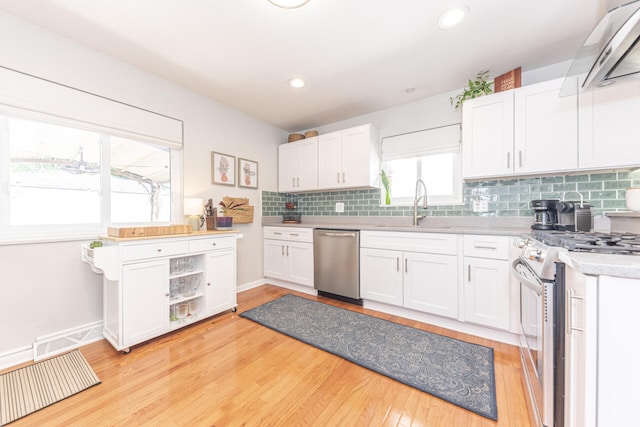 2041 Norfolk Ave, Ann Arbor, MI 48103 - kitchen with stainless steel appliances, exhaust hood, white cabinetry, light countertops, and recessed lighting