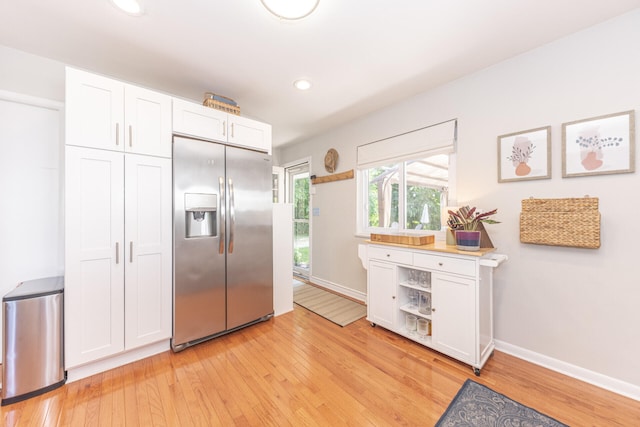 2041 Norfolk Ave, Ann Arbor, MI 48103 - kitchen featuring stainless steel refrigerator with ice dispenser, light wood finished floors, white cabinetry, recessed lighting, and light countertops