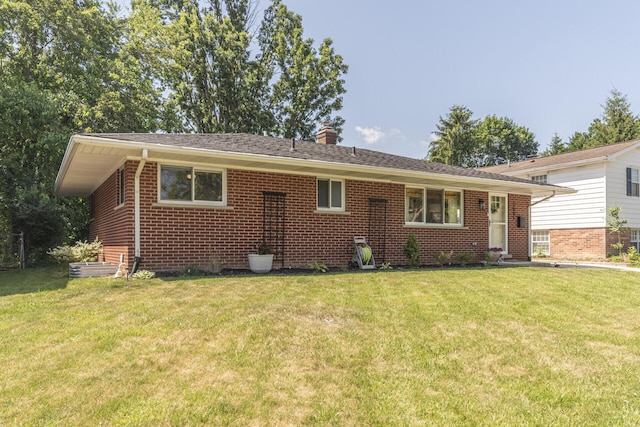 2041 Norfolk Ave, Ann Arbor, MI 48103 - view of front of property featuring brick siding, a chimney, and a front yard