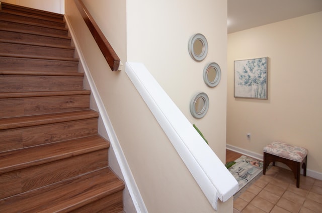 609 Watersedge Dr, Ann Arbor, MI 48105 - stairway featuring tile patterned flooring and baseboards