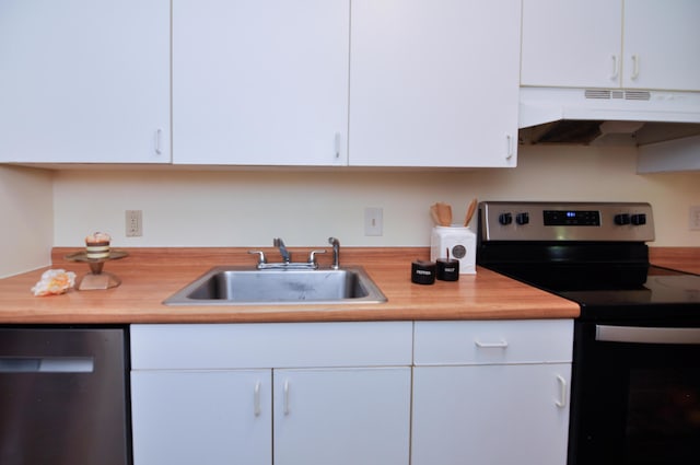 609 Watersedge Dr, Ann Arbor, MI 48105 - kitchen featuring under cabinet range hood, range with electric stovetop, stainless steel dishwasher, white cabinetry, and butcher block counters