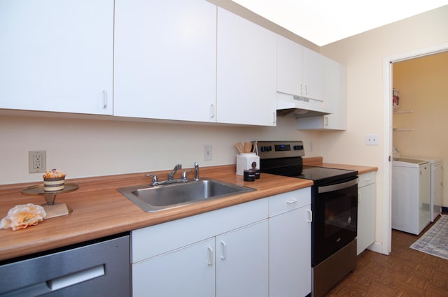609 Watersedge Dr, Ann Arbor, MI 48105 - kitchen featuring stainless steel appliances, under cabinet range hood, washing machine and dryer, light countertops, and white cabinets