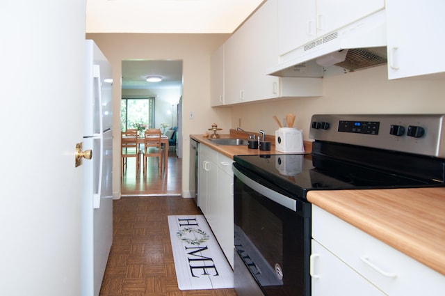 609 Watersedge Dr, Ann Arbor, MI 48105 - kitchen featuring stainless steel electric range, under cabinet range hood, freestanding refrigerator, white cabinets, and light countertops