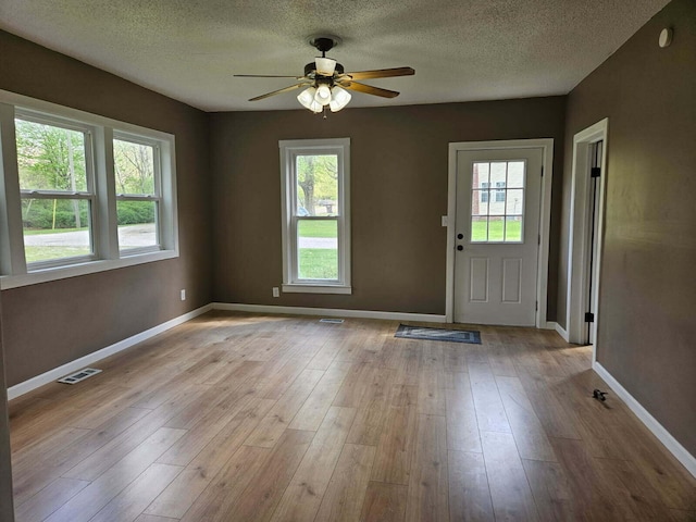 4084 Seneca St, Weston, MI 49289 - foyer with a ceiling fan, healthy amount of natural light, a textured ceiling, and wood finished floors
