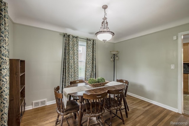 3070 Old Orchard Dr, Waterford, MI 48328 - dining area featuring wood finished floors and ornamental molding