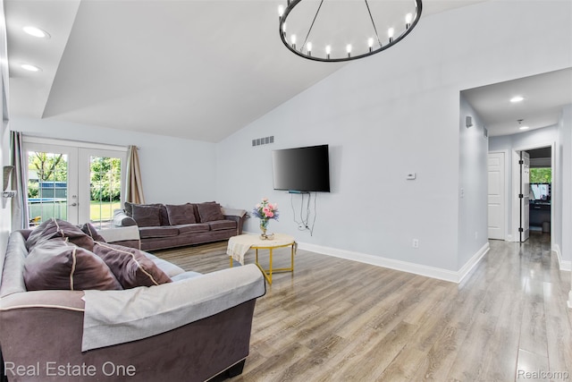 2930 Wisconsin Rd, Troy, MI 48083 - living area featuring healthy amount of natural light, light wood finished floors, a chandelier, french doors, and high vaulted ceiling
