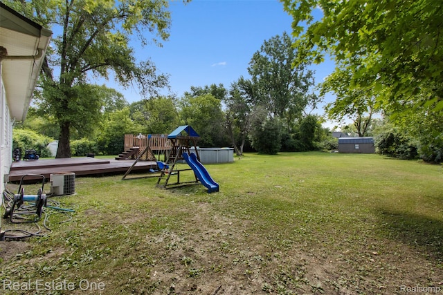 2930 Wisconsin Rd, Troy, MI 48083 - view of grassy yard with a playground, a deck, and view of wooded area