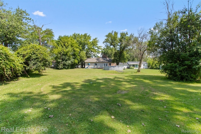 2930 Wisconsin Rd, Troy, MI 48083 - view of green lawn with a deck