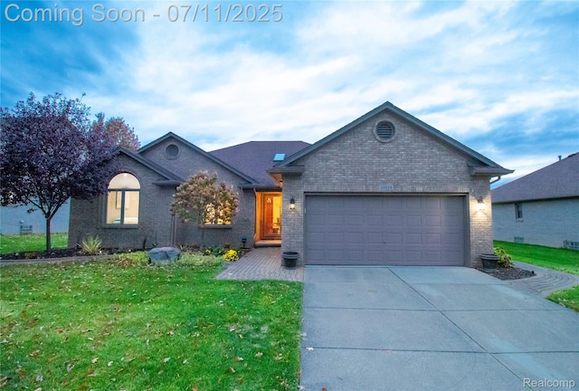 32529 Pine Ridge Dr, Warren, MI 48093 - view of front of house featuring brick siding, an attached garage, a front yard, and driveway