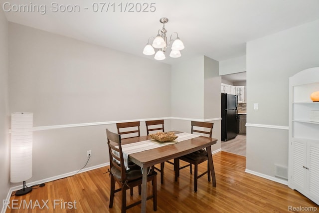 5910 Hillsboro Rd, Davisburg, MI 48350 - dining room featuring a chandelier and light wood-type flooring