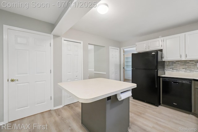 5910 Hillsboro Rd, Davisburg, MI 48350 - kitchen featuring black appliances, light wood-type flooring, white cabinetry, and light countertops