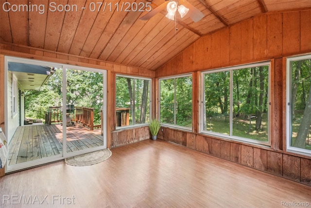 5910 Hillsboro Rd, Davisburg, MI 48350 - unfurnished sunroom featuring lofted ceiling, wooden walls, wood ceiling, plenty of natural light, and wood finished floors