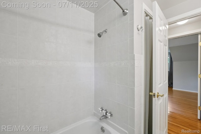 5910 Hillsboro Rd, Davisburg, MI 48350 - bathroom featuring shower / washtub combination and wood finished floors