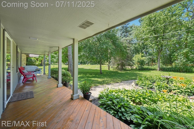 5910 Hillsboro Rd, Davisburg, MI 48350 - wooden porch featuring a yard and view of wooded area