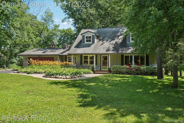 5910 Hillsboro Rd, Davisburg, MI 48350 - new england style home with a front yard, board and batten siding, a chimney, and a garage