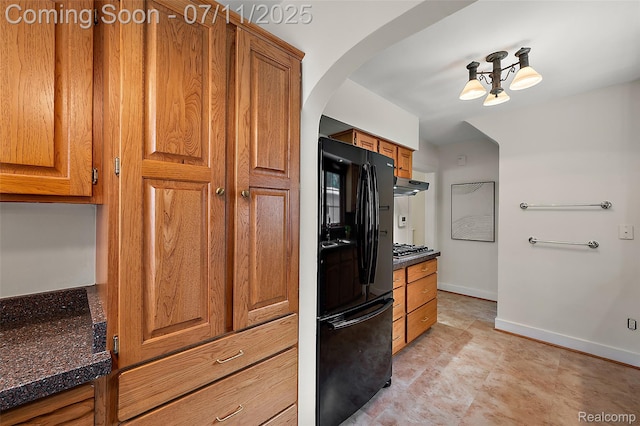 132 Illinois Ave, Pontiac, MI 48341 - kitchen with freestanding refrigerator, brown cabinetry, and ventilation hood