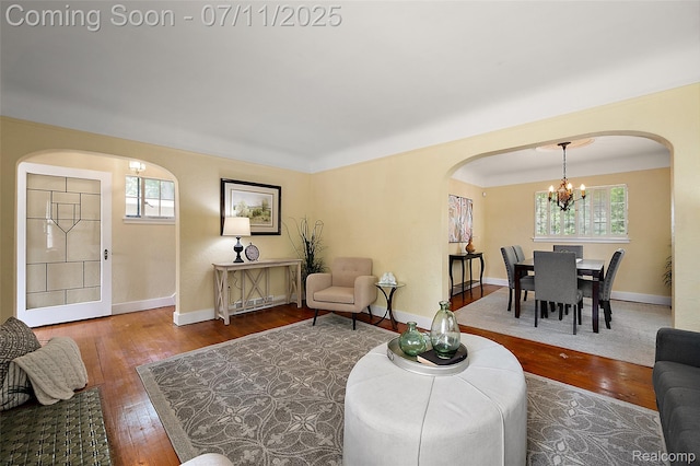 132 Illinois Ave, Pontiac, MI 48341 - living area featuring arched walkways, a chandelier, and healthy amount of natural light