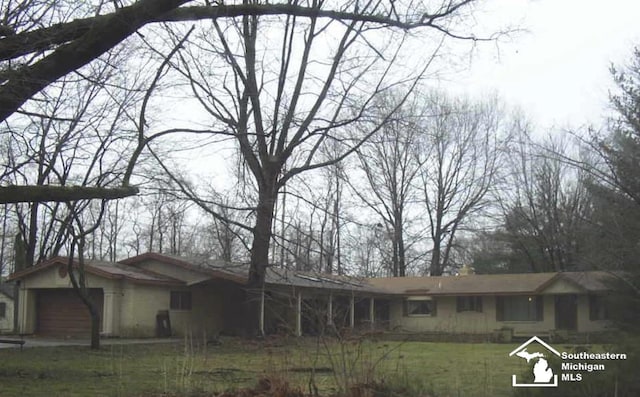 10931 Telegraph Rd, Erie, MI 48133 - ranch-style house with an attached garage and a front yard