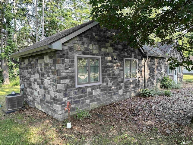 10931 Telegraph Rd, Erie, MI 48133 - view of side of home with stone siding and a shingled roof