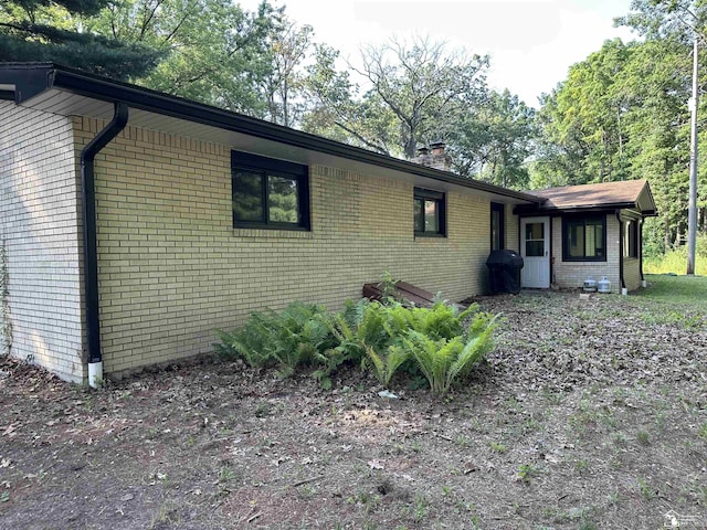 10931 Telegraph Rd, Erie, MI 48133 - view of front facade featuring brick siding and a chimney