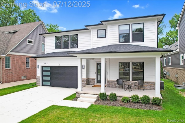 1212 Royal Ave, Royal Oak, MI 48073 - view of front of house with covered porch, driveway, an attached garage, a front lawn, and stone siding