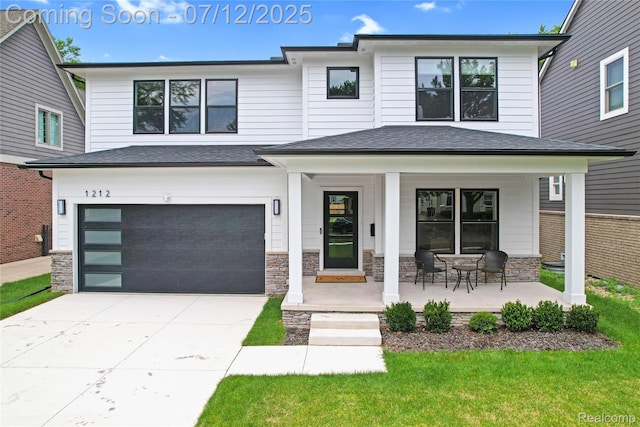 1212 Royal Ave, Royal Oak, MI 48073 - view of front of house with covered porch, a garage, concrete driveway, stone siding, and roof with shingles