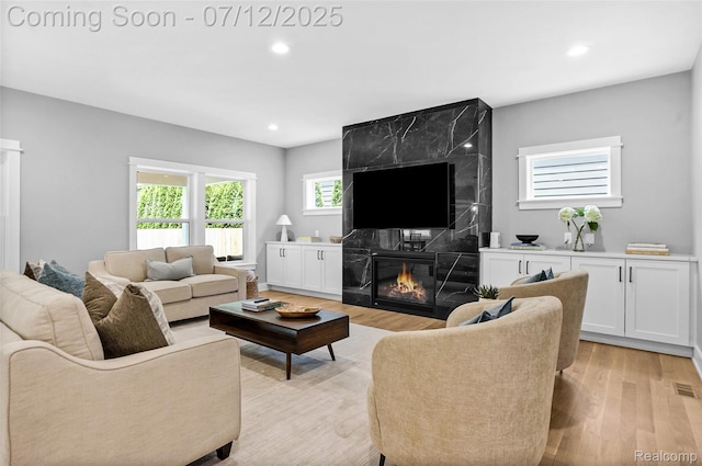 1212 Royal Ave, Royal Oak, MI 48073 - living room with light wood-style floors, a high end fireplace, and recessed lighting