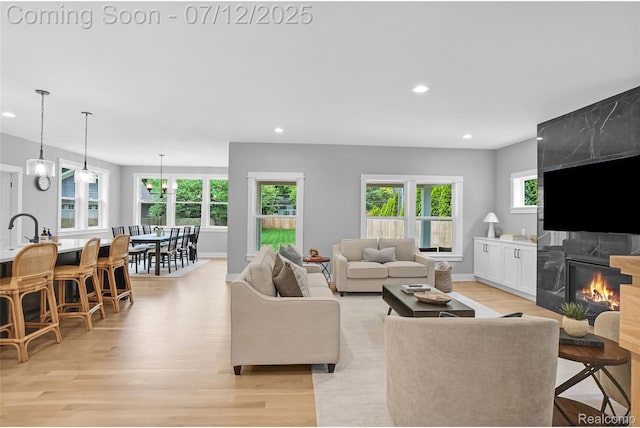 1212 Royal Ave, Royal Oak, MI 48073 - living area with light wood-style floors, recessed lighting, and a tiled fireplace