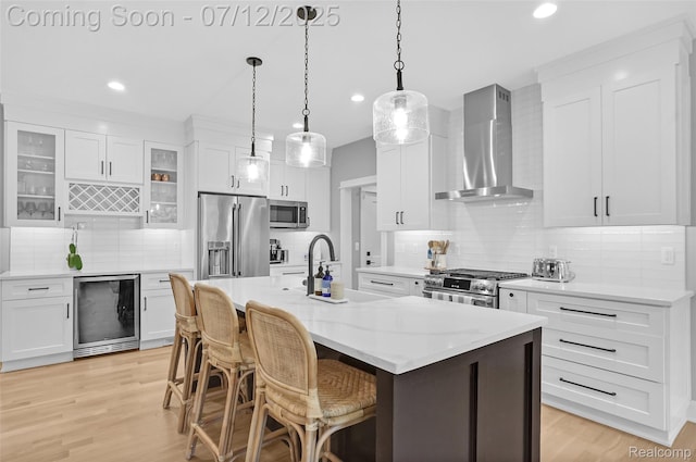 1212 Royal Ave, Royal Oak, MI 48073 - kitchen with wall chimney range hood, premium appliances, wine cooler, tasteful backsplash, and recessed lighting