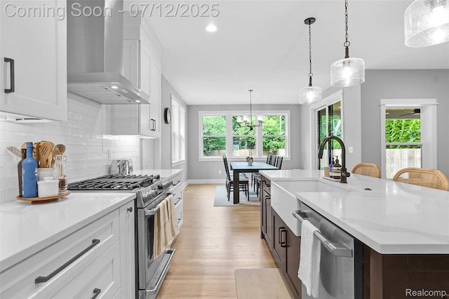 1212 Royal Ave, Royal Oak, MI 48073 - kitchen featuring wall chimney exhaust hood, appliances with stainless steel finishes, light wood-type flooring, white cabinets, and recessed lighting