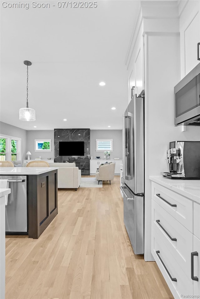 1212 Royal Ave, Royal Oak, MI 48073 - kitchen with appliances with stainless steel finishes, white cabinetry, light wood-type flooring, healthy amount of natural light, and recessed lighting