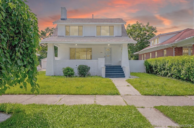 163 Moss St, Highland Park, MI 48203 - view of front facade with a chimney, a front yard, covered porch, brick siding, and a shingled roof