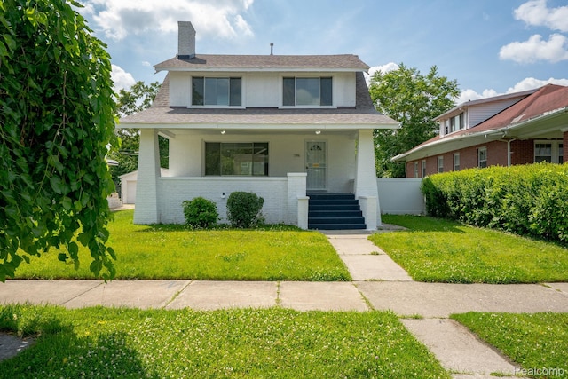 163 Moss St, Highland Park, MI 48203 - view of front of property with brick siding, a front yard, a porch, a chimney, and roof with shingles