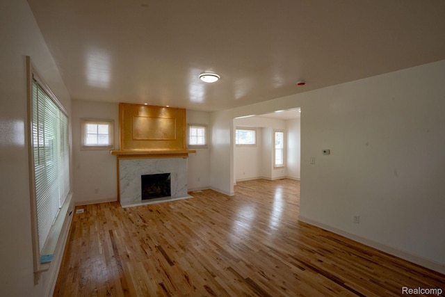 163 Moss St, Highland Park, MI 48203 - unfurnished living room featuring plenty of natural light, light wood-style floors, and a fireplace