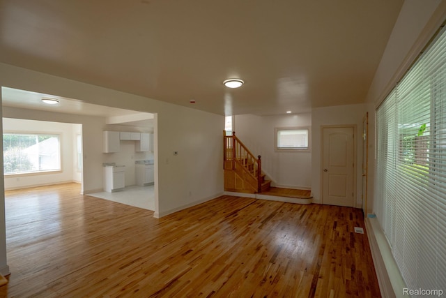 163 Moss St, Highland Park, MI 48203 - empty room featuring light wood-style flooring and stairs