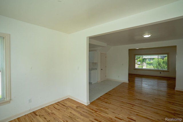 163 Moss St, Highland Park, MI 48203 - empty room featuring light wood finished floors and vaulted ceiling