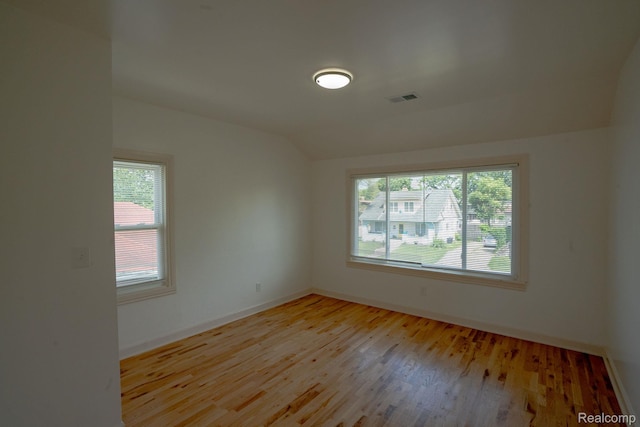 163 Moss St, Highland Park, MI 48203 - empty room with vaulted ceiling, plenty of natural light, and light wood-style flooring