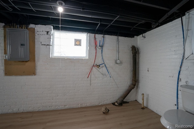163 Moss St, Highland Park, MI 48203 - basement featuring electric panel, brick wall, and wood finished floors
