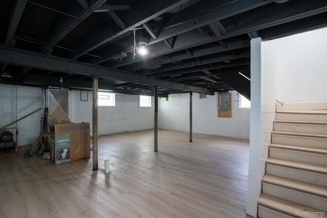 163 Moss St, Highland Park, MI 48203 - below grade area with electric panel, wood finished floors, and stairs