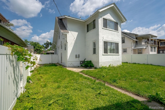 163 Moss St, Highland Park, MI 48203 - back of house featuring a fenced backyard and stucco siding